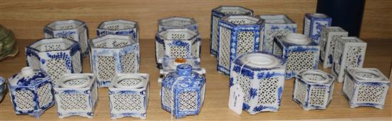 Twenty one Chinese blue and white pierced pot pourri vases and candle holders (various shapes and sizes) and two small rice bowls